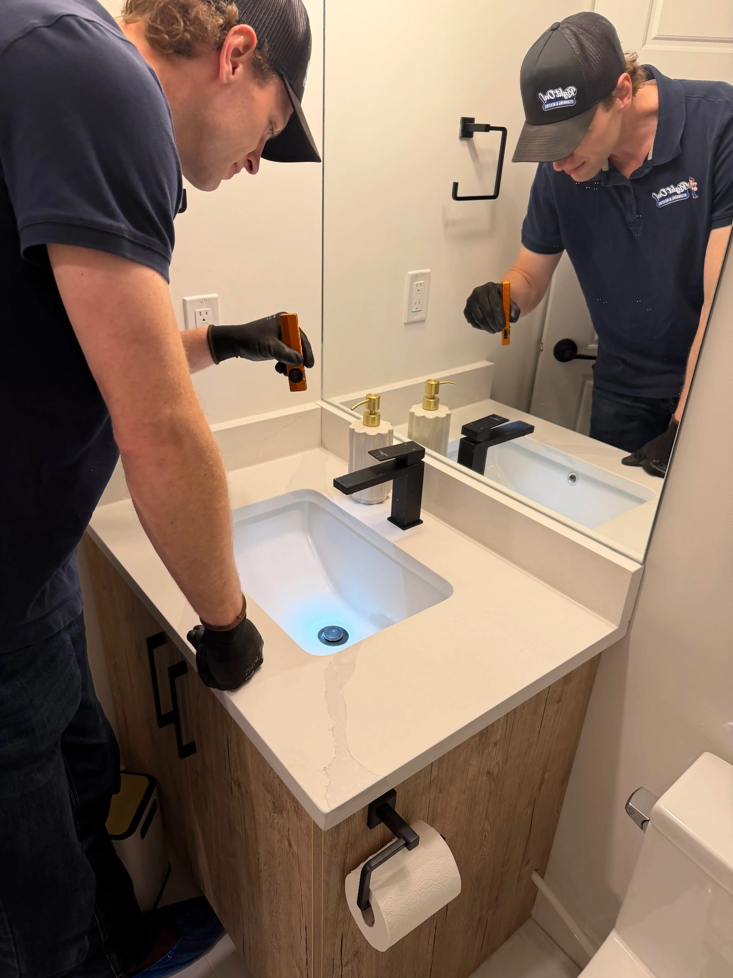Noah diagnosing a plumbing leak in an Okotoks home