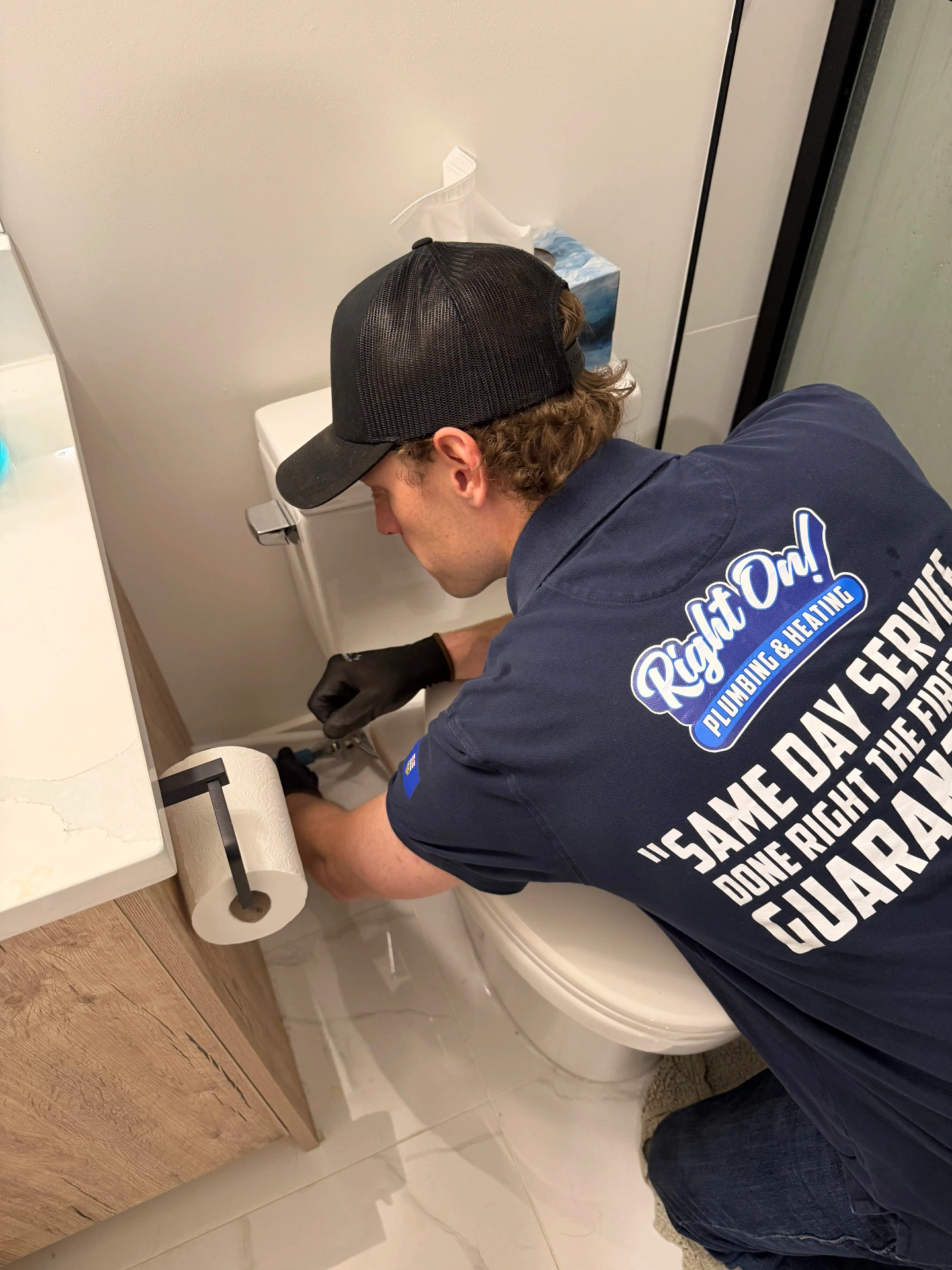 Noah repairing a toilet on site