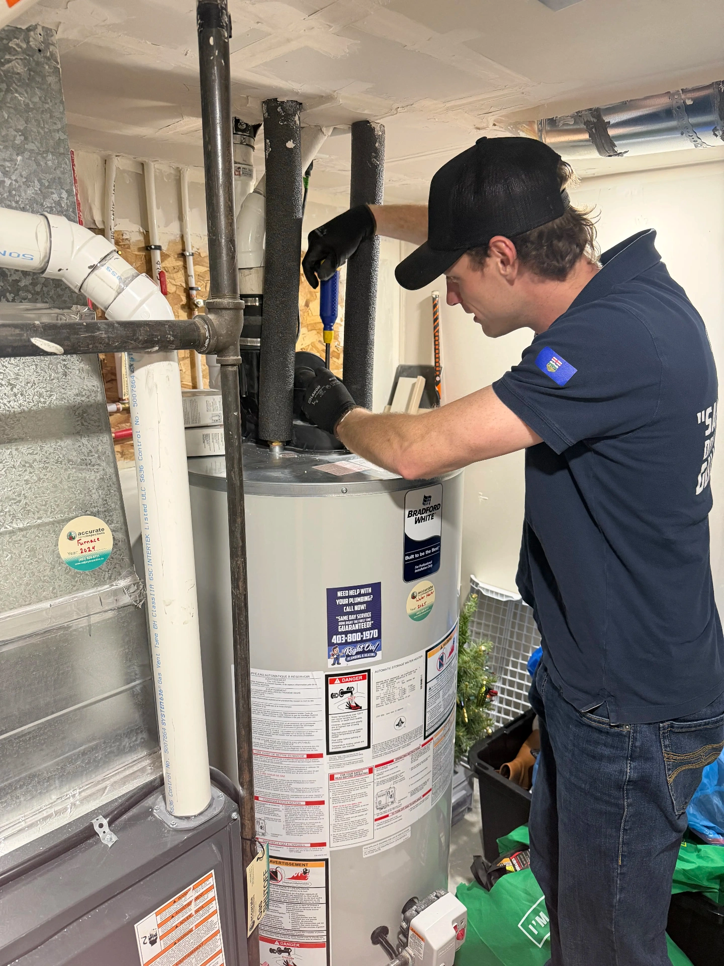 Noah inspecting a water heater installation